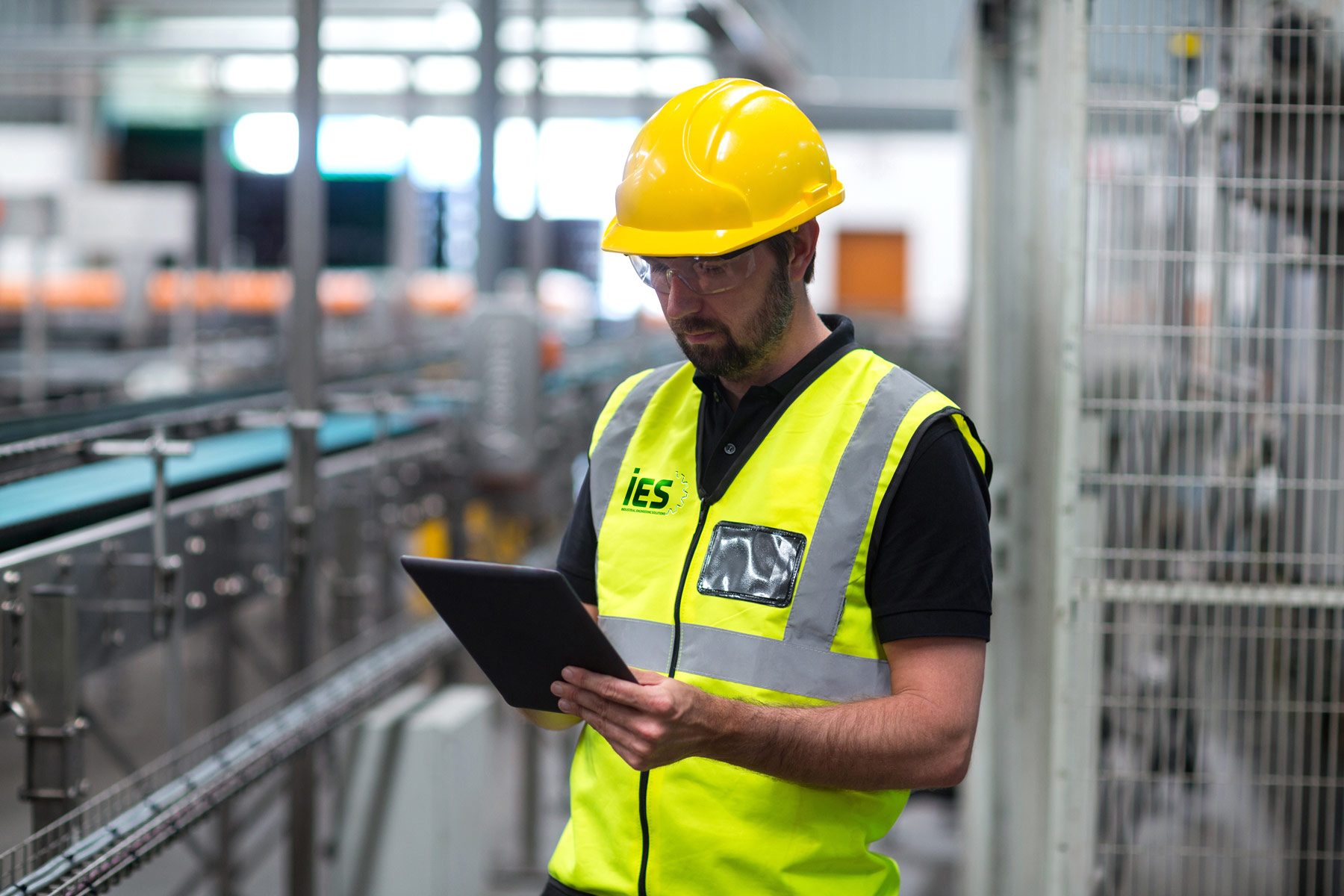 IES-branded engineer with tablet conducting a facility site assessment